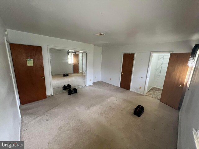 interior space with ensuite bath and carpet flooring