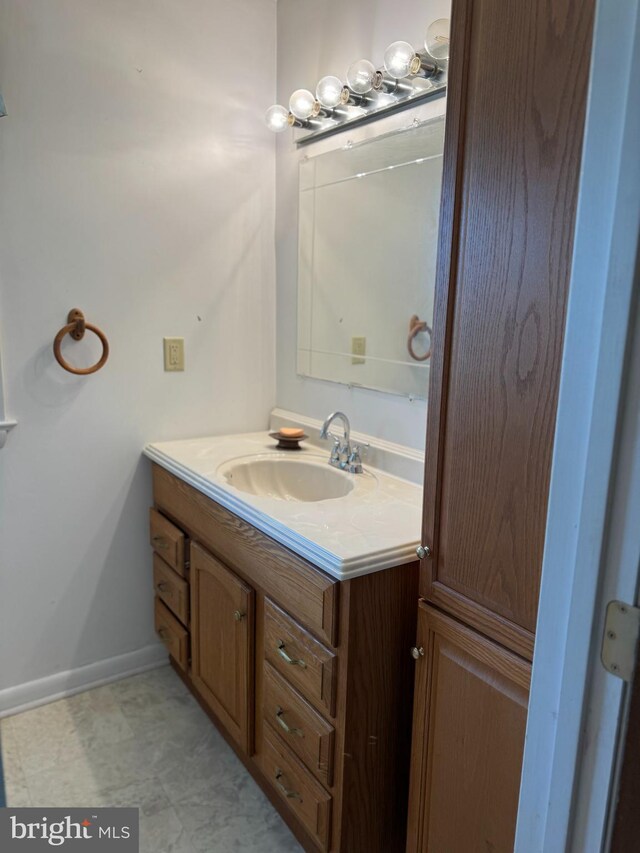 bathroom featuring baseboards and vanity