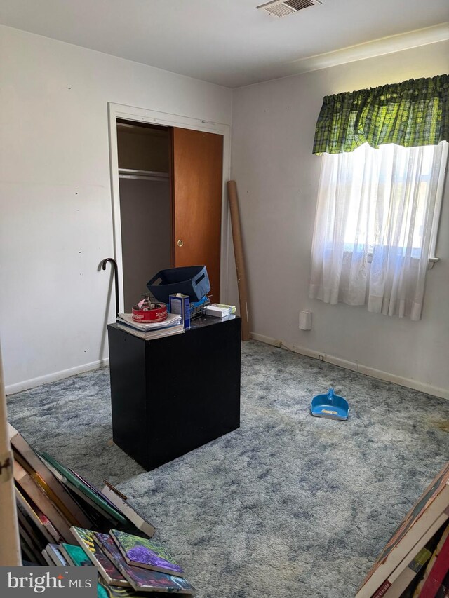 bedroom featuring baseboards, visible vents, carpet floors, and a closet