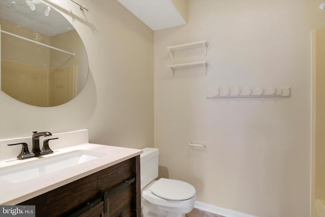bathroom featuring vanity, walk in shower, and toilet