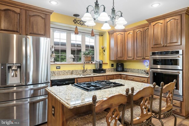 1 Pinkerton Ct, Stafford, VA 22554 - kitchen with black appliances, a chandelier, a sink, light stone countertops, and a center island
