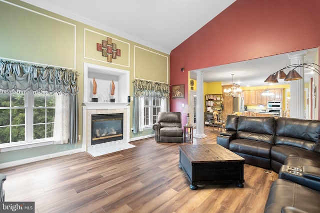 1 Pinkerton Ct, Stafford, VA 22554 - living area with decorative columns, high vaulted ceiling, a chandelier, a fireplace, and wood finished floors