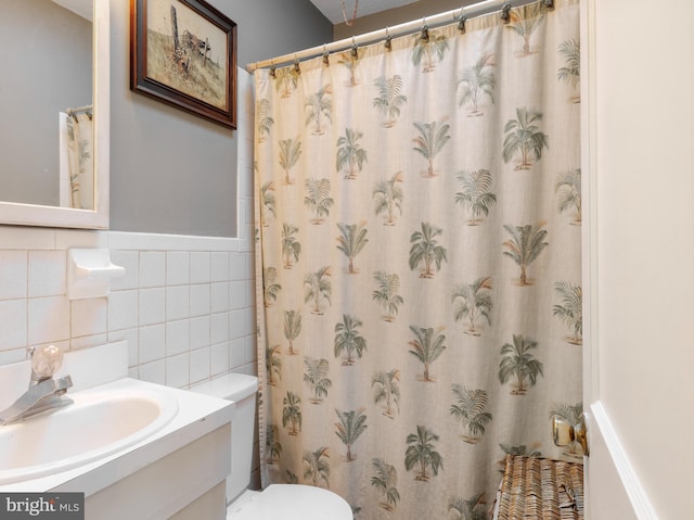 502 Page St, Woodbury, NJ 08096 - bathroom featuring tile walls, curtained shower, a wainscoted wall, vanity, and toilet
