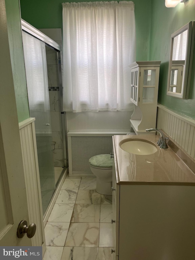 bathroom with vanity, marble finish floor, a shower stall, and toilet