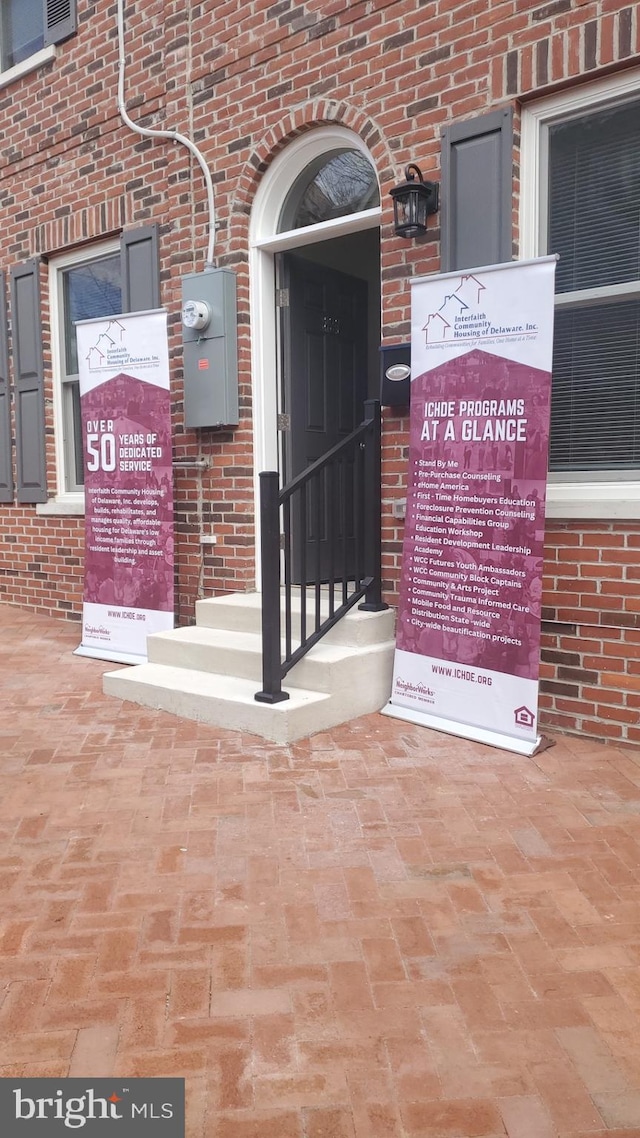 property entrance featuring brick siding