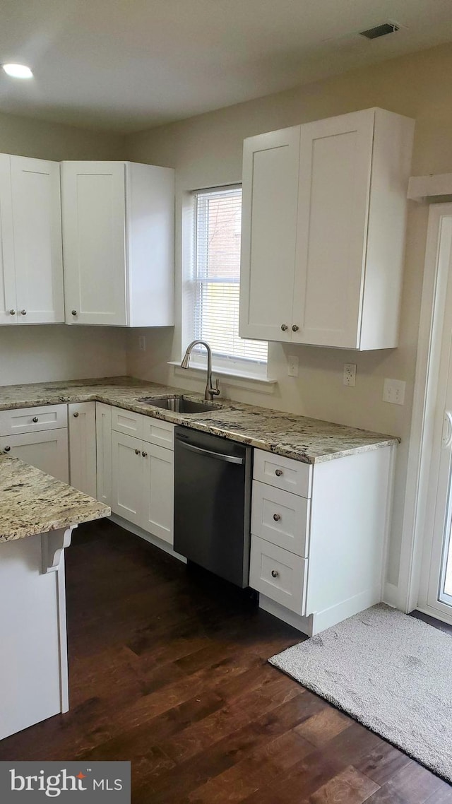 kitchen featuring light stone counters, dark wood-style floors, white cabinetry, dishwasher, and a sink