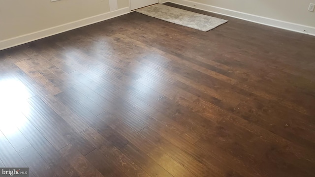 room details with baseboards and wood finished floors