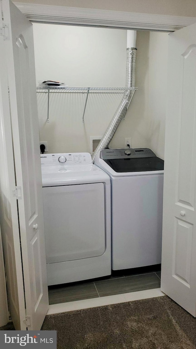 laundry area with tile patterned floors, washer and clothes dryer, and laundry area