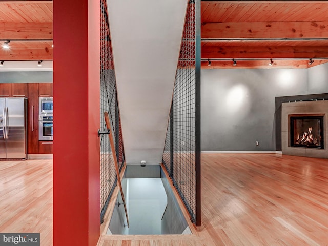 3411 Woodberry Ave, Baltimore, MD 21211 - interior space with baseboards, rail lighting, beamed ceiling, wood ceiling, and wood finished floors