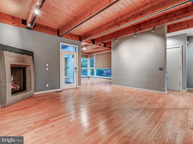 3411 Woodberry Ave, Baltimore, MD 21211 - unfurnished living room featuring track lighting, wood ceiling, a tiled fireplace, and beam ceiling