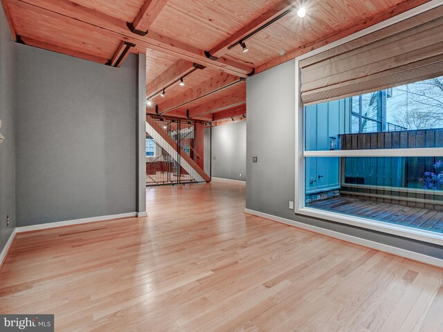 3411 Woodberry Ave, Baltimore, MD 21211 - unfurnished living room featuring track lighting, wood ceiling, wood finished floors, and baseboards