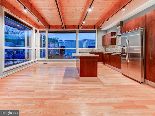 3411 Woodberry Ave, Baltimore, MD 21211 - kitchen with stainless steel fridge with ice dispenser, track lighting, wall chimney range hood, light wood-style floors, and backsplash