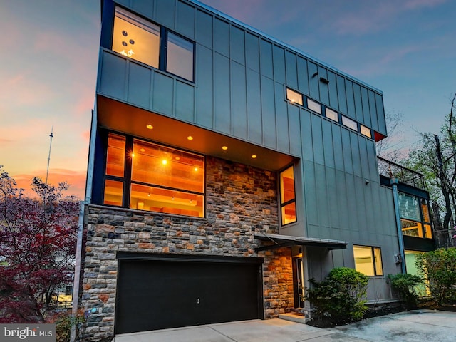 3411 Woodberry Ave, Baltimore, MD 21211 - contemporary house featuring board and batten siding, driveway, stone siding, and a garage