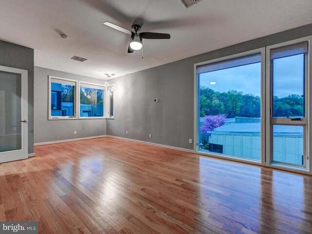 3411 Woodberry Ave, Baltimore, MD 21211 - spare room with visible vents, a ceiling fan, wood finished floors, and a healthy amount of sunlight