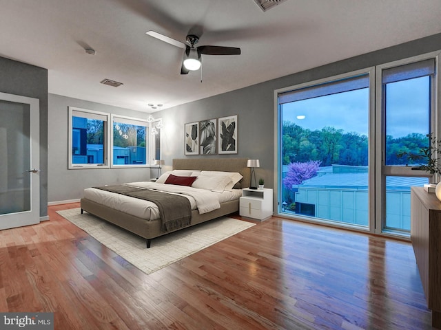 3411 Woodberry Ave, Baltimore, MD 21211 - bedroom with access to outside, a ceiling fan, visible vents, wood finished floors, and baseboards