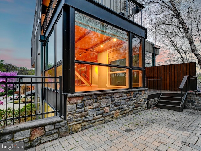 3411 Woodberry Ave, Baltimore, MD 21211 - view of side of home featuring stone siding and a balcony