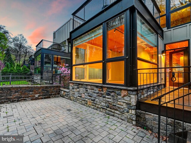 3411 Woodberry Ave, Baltimore, MD 21211 - property exterior at dusk featuring stone siding and fence