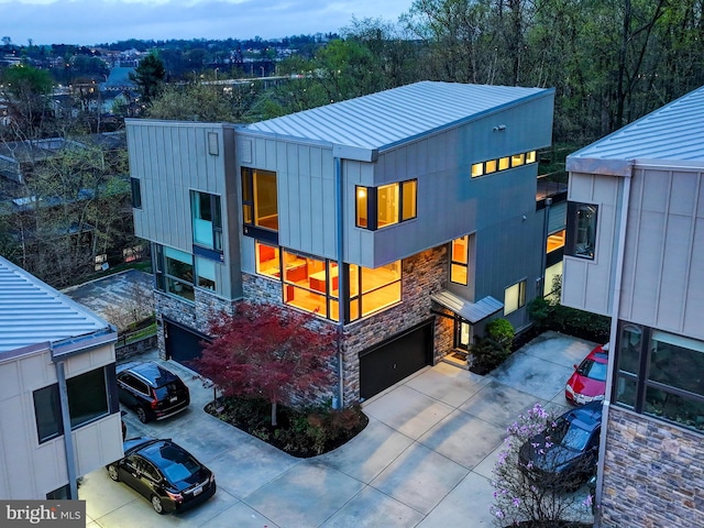 3411 Woodberry Ave, Baltimore, MD 21211 - modern home featuring a garage, metal roof, driveway, and stone siding