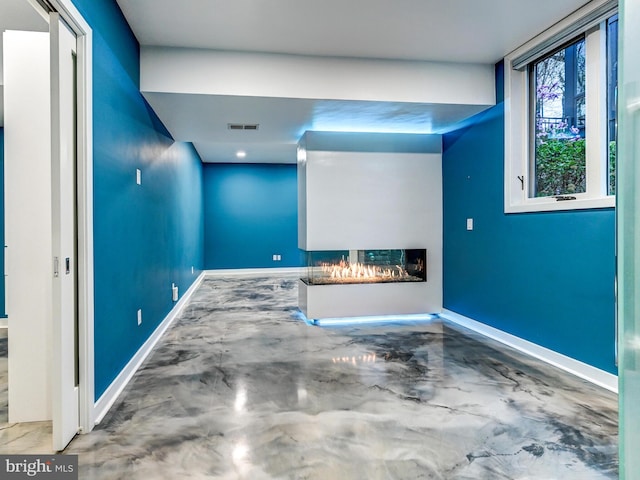 3411 Woodberry Ave, Baltimore, MD 21211 - interior space with a lit fireplace, finished concrete floors, baseboards, and visible vents