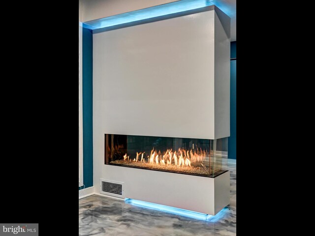 3411 Woodberry Ave, Baltimore, MD 21211 - details featuring visible vents, a multi sided fireplace, and finished concrete flooring