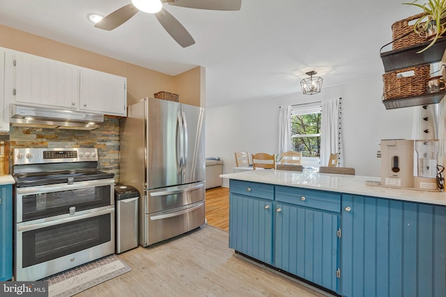 305 W Poplar Rd, Sterling, VA 20164 - kitchen with light wood finished floors, stainless steel appliances, blue cabinetry, ceiling fan, and under cabinet range hood
