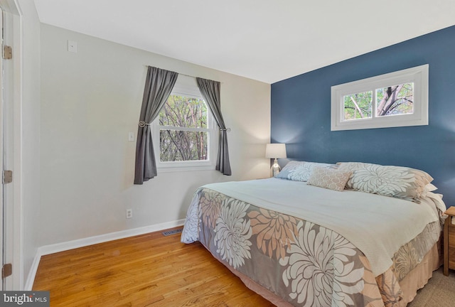 305 W Poplar Rd, Sterling, VA 20164 - bedroom with visible vents, baseboards, and wood finished floors