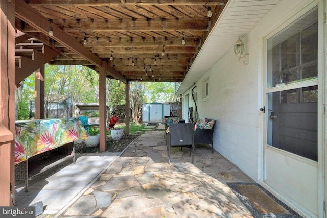 305 W Poplar Rd, Sterling, VA 20164 - view of patio featuring an outdoor structure and a storage shed