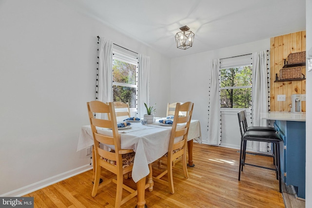 305 W Poplar Rd, Sterling, VA 20164 - dining room featuring a chandelier, light wood-style flooring, and baseboards