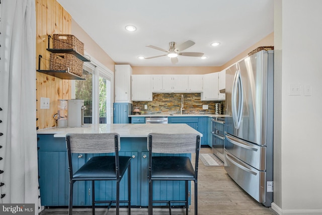 305 W Poplar Rd, Sterling, VA 20164 - kitchen featuring stainless steel appliances, open shelves, a ceiling fan, a sink, and a peninsula