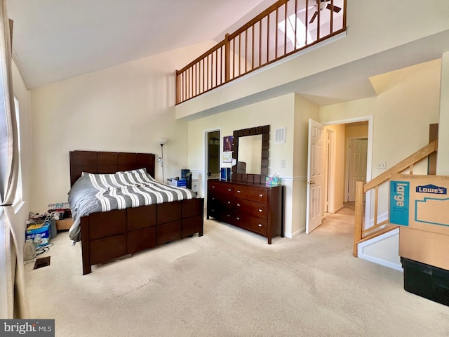 bedroom featuring a high ceiling, carpet floors, and baseboards