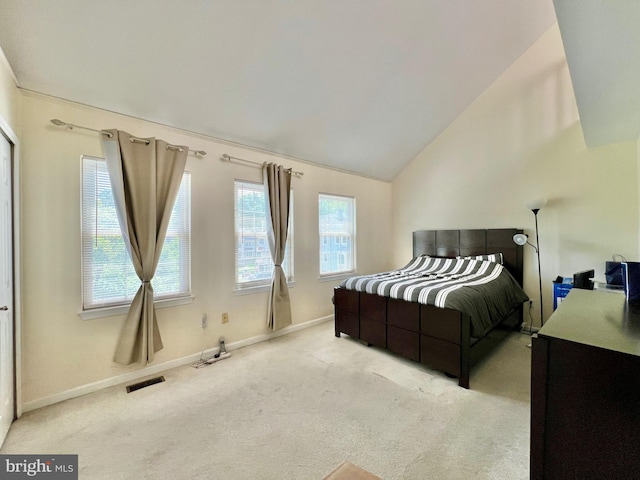 bedroom with carpet, visible vents, baseboards, and lofted ceiling