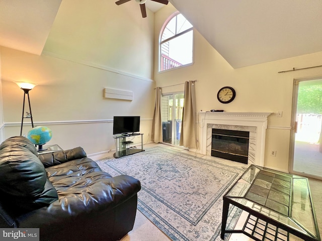 living area featuring a wall mounted air conditioner, a fireplace, ceiling fan, and high vaulted ceiling
