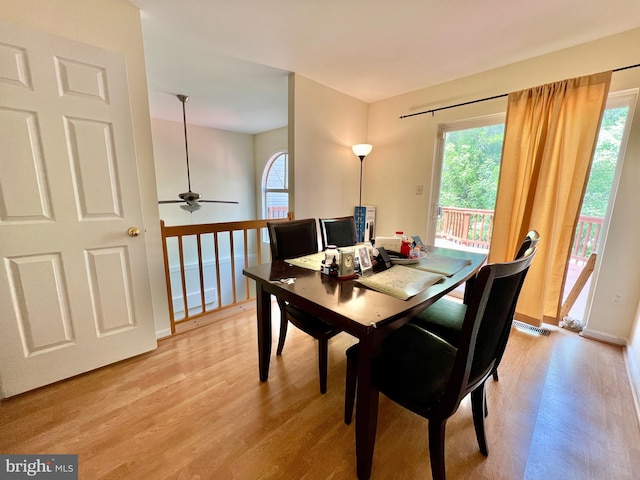 dining room with a ceiling fan, visible vents, and light wood-type flooring