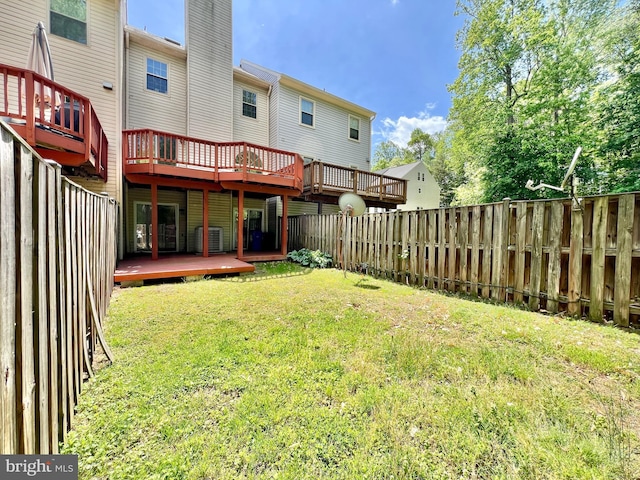 back of house with a fenced backyard, a wooden deck, a chimney, and a yard