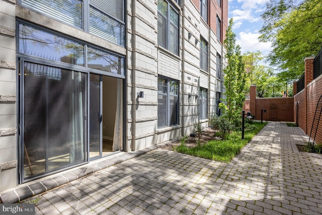 view of side of property featuring fence and a patio