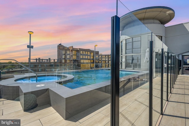 view of pool with a pool with connected hot tub
