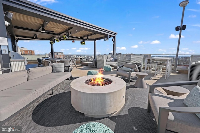 view of patio / terrace featuring an outdoor living space with a fire pit