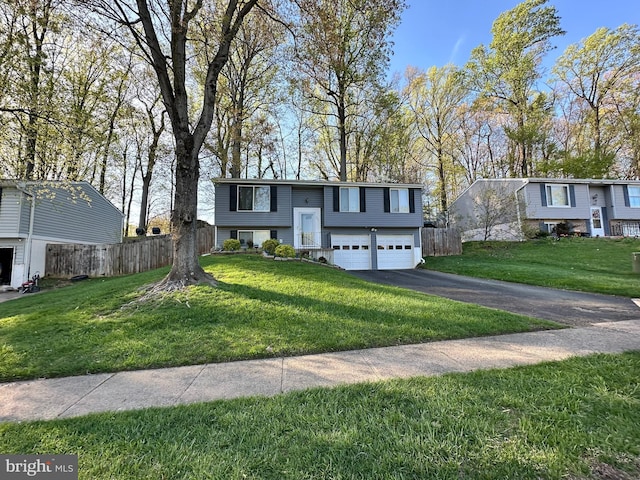 raised ranch featuring driveway and an attached garage