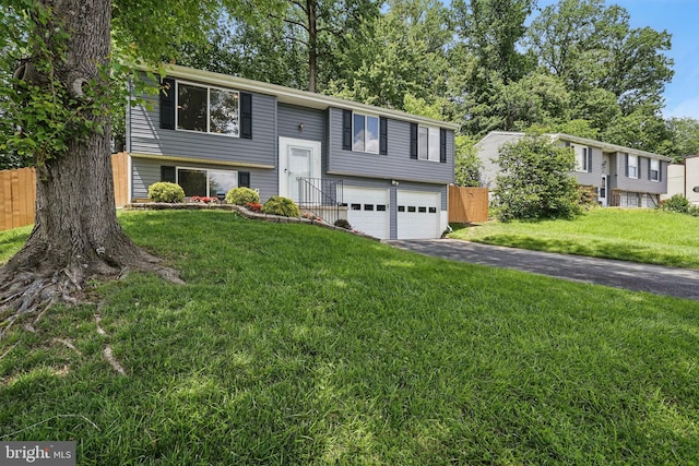 split foyer home with asphalt driveway and an attached garage