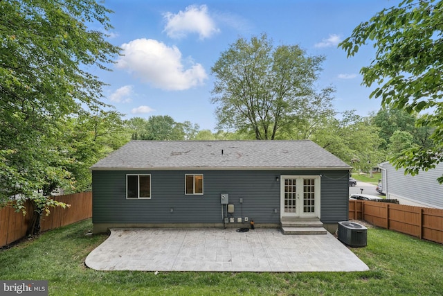 rear view of house featuring french doors, a patio area, central AC unit, and a shingled roof