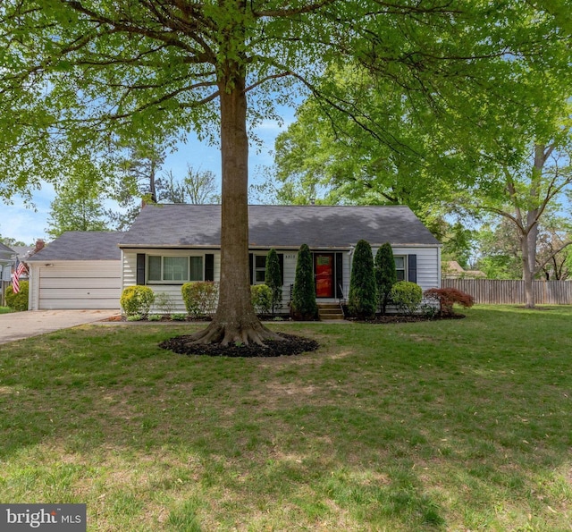 ranch-style home featuring a garage, fence, a front yard, and concrete driveway