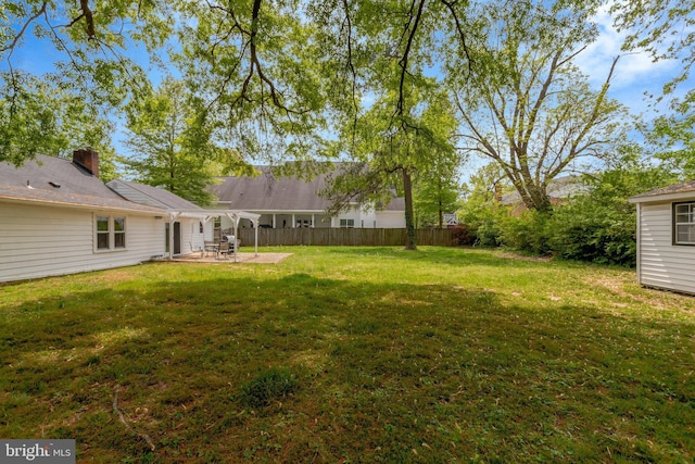 view of yard with fence and a patio area