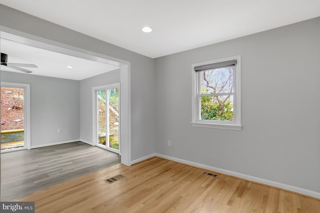 unfurnished room featuring recessed lighting, light wood-type flooring, visible vents, and baseboards