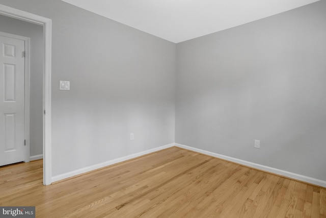 unfurnished room featuring baseboards and wood finished floors