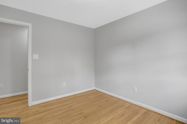 unfurnished room featuring baseboards and wood finished floors