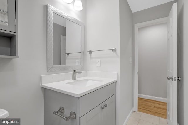 bathroom featuring vanity, baseboards, and tile patterned flooring