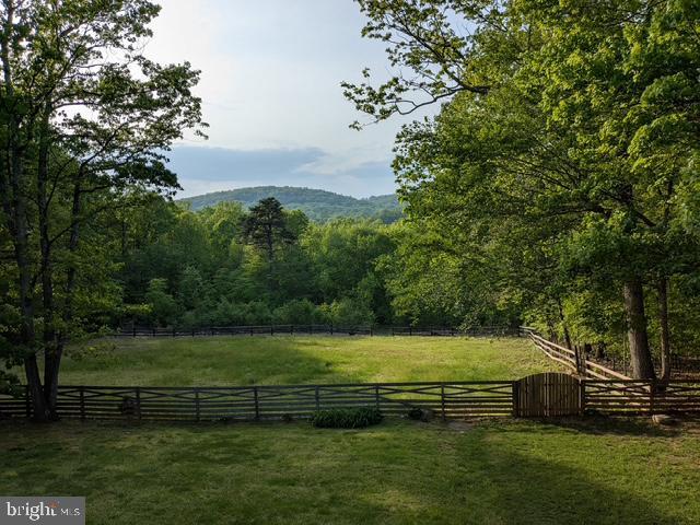mountain view featuring rural landscape and a heavily wooded area