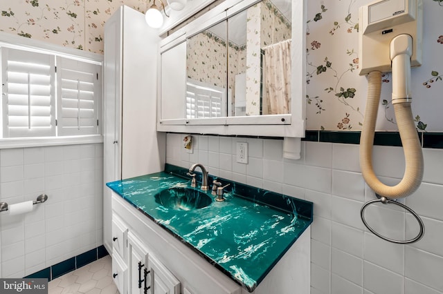 bathroom featuring vanity, tile walls, wallpapered walls, and tile patterned floors