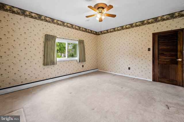 carpeted spare room with wallpapered walls, baseboards, a baseboard heating unit, and ceiling fan