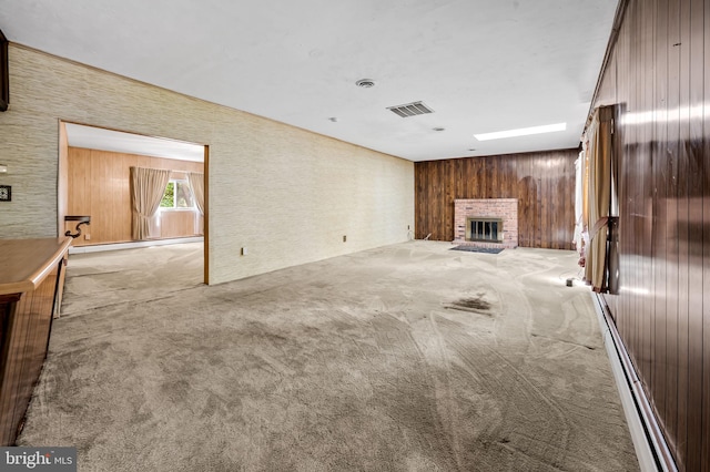 unfurnished living room featuring visible vents, a brick fireplace, and carpet floors